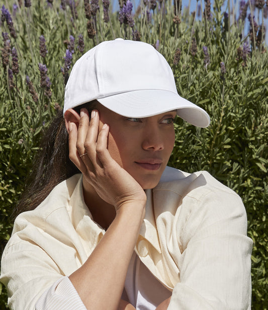 Female model in a plain white workwear cap suitable for business branding.